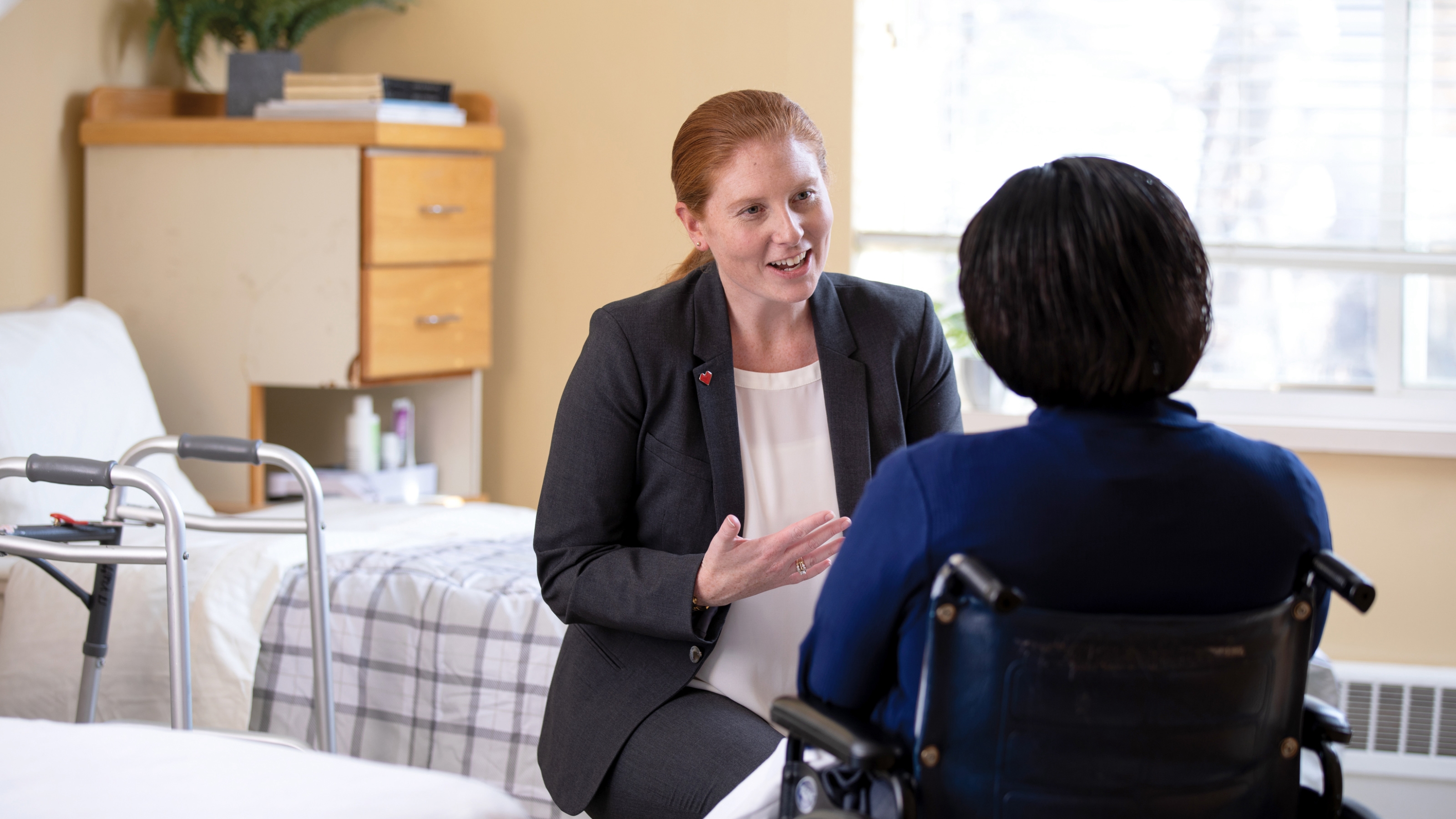 Maura Eldridge, Omnicare Consultant Pharmacist talking to a woman in a wheelchair