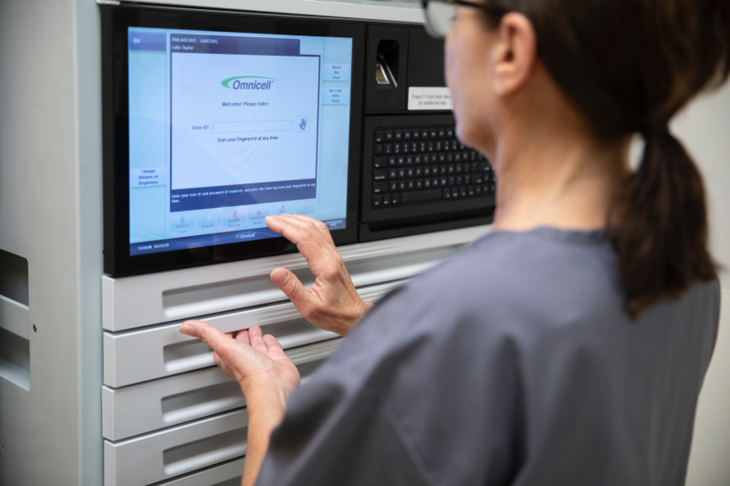 A resident care facility worker using an Omnicell, which dispenses patient medication