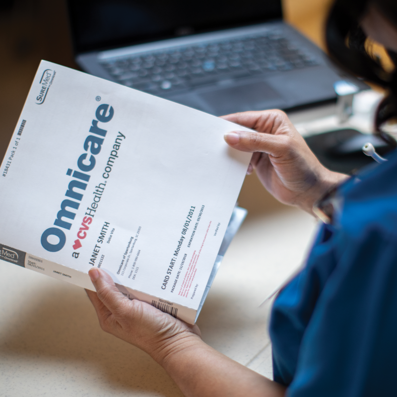 woman holding a patient medication record from Omnicare