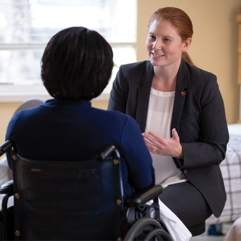 Maura Eldridge, Omnicare Consultant Pharmacist talking to a woman in a wheelchair